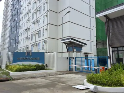 a building with a sign on the side of it at The Dwelling Place at Metrotowne Las Pinas in Manila