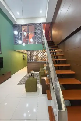 a staircase in a building with a green wall at Modern Loft in Newport City - 2BR and 2BA in Manila