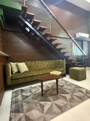 a living room with a couch and a table at Modern Loft in Newport City - 2BR and 2BA in Manila