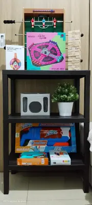 a shelf filled with books and a potted plant at 1BR Amenity View Room at Shore Residences, Pasay Near MOA & Airport in Manila