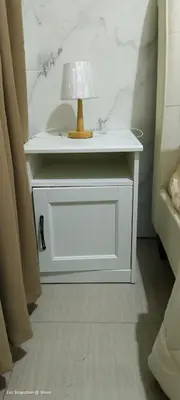 a white end table with a lamp on top of it at 1BR Amenity View Room at Shore Residences, Pasay Near MOA & Airport in Manila