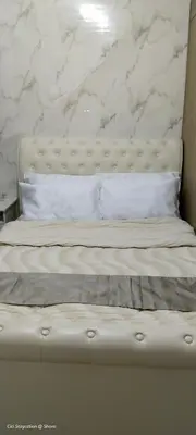 a white bed with a white marble wall at 1BR Amenity View Room at Shore Residences, Pasay Near MOA & Airport in Manila