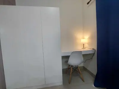 a white desk with a chair and a lamp at GB Travelers Rest at Shore 2 Residences in Manila