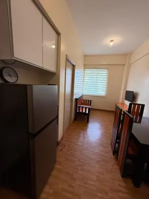 a kitchen with a refrigerator and a living room at Cypress 108 in Manggahan