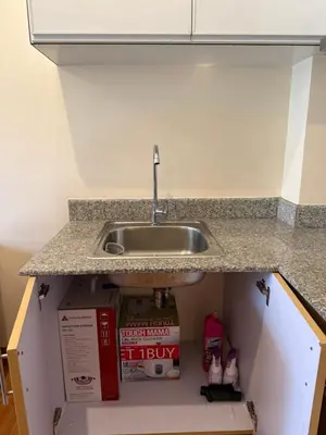 a kitchen counter with a sink and a box under it at Cypress 108 in Manggahan