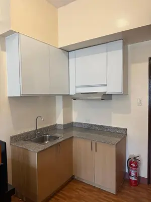 a kitchen with white cabinets and a sink at Cypress 108 in Manggahan