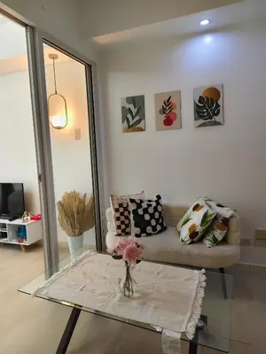 a living room with a couch and a table at MG Labels Property in Manila
