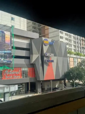 a building with a sign on the side of it at Cozy 1BR Pioneer Woodland SM Light Boni Mandaluyong in Manila