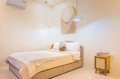 a bedroom with a bed and a mirror on the wall at Casa Dapyo in Sampong