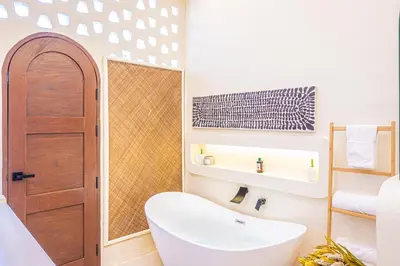 a bathroom with a white tub and a sink at Casa Dapyo in Sampong