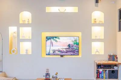 a living room with a painting on a wall at Casa Dapyo in Sampong