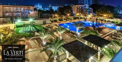 an overhead view of a pool with palm trees and buildings at 1BR LaVerti Minalist affordable family staycation in Manila