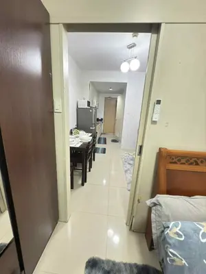 a hallway with a dining room and a dining table at 1Br Sea Residences affordable staycatiom in Manila