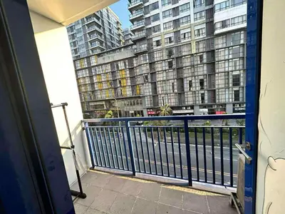 a balcony with a view of a large building at 1Br Sea Residences affordable staycatiom in Manila
