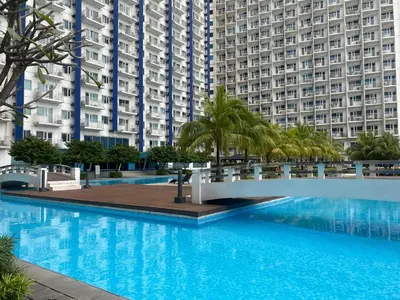 a large swimming pool in front of tall buildings at Jazz Tower A Cozy Room for 2 Adults in Manila