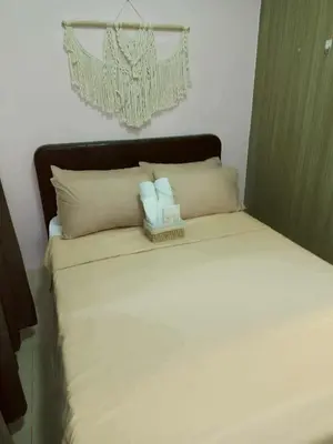 a bed with two stuffed animals on top of it at Boho Cove PH in Manila