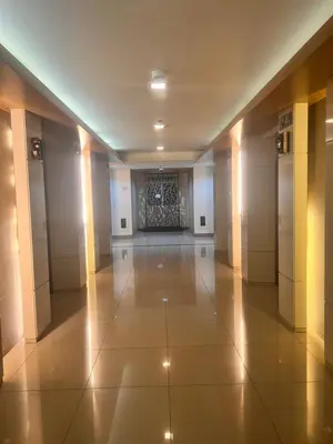 an empty hallway of a building with lights on at Boho Cove PH in Manila