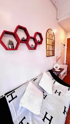 a bedroom with two pillows and a wall with two shelves at Minimalist Condo near NAIA Free Netflix Pool Balcony in Manila