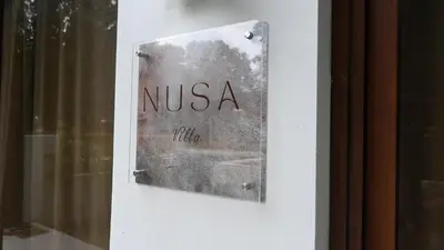 a sign on a door with the word nisska at Nusa Villa in Malinta
