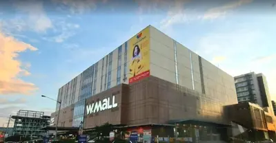 a large building with a sign on the side of it at Modern MOA Escape, Work, Chill & City Views in Manila
