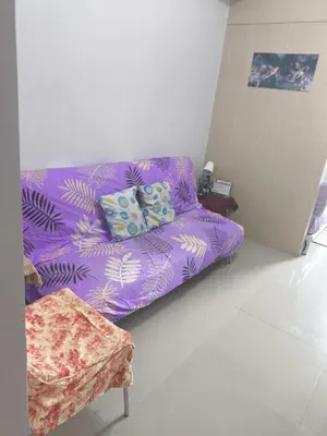 a purple couch sitting in a living room at Sea Residence-Rosa in Manila