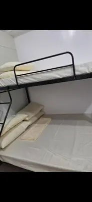 a white bunk bed with white sheets and pillows on it at SMDC South Residences in Manila