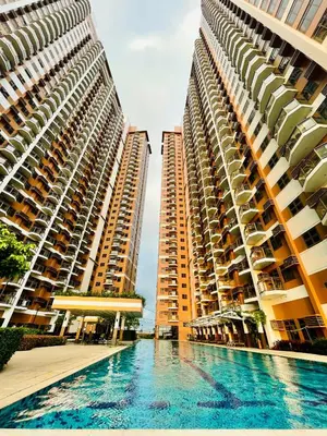 two tall buildings with a pool in front of them at Urbanstay at The Radiance Manila Bay in Manila
