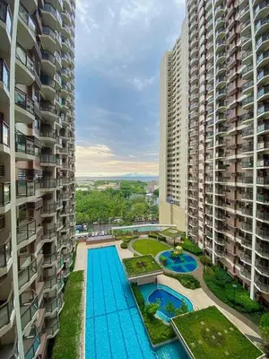 an overhead view of a swimming pool between two tall buildings at Urbanstay at The Radiance Manila Bay in Manila