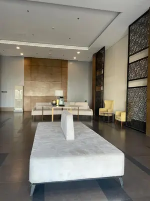a hotel room with a bed and tables and chairs at Urbanstay at The Radiance Manila Bay in Manila