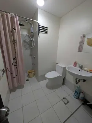 a bathroom with a toilet and a sink at Lily s Place in Manila