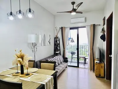 a living room with a table and a couch at The Hive Cozy 1-BR Retreat in Taytay