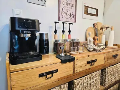 a wooden dresser with a coffee maker on top of it at The Hive Cozy 1-BR Retreat in Taytay