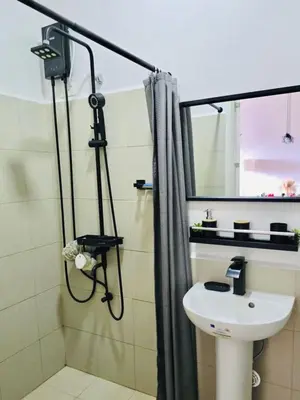 a bathroom with a sink and a shower at The Hive Cozy 1-BR Retreat in Taytay