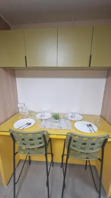 a yellow table with three sinks and two chairs at Kage-no-Wa Suite Netflix, Disney, HBO 2BR in Manila