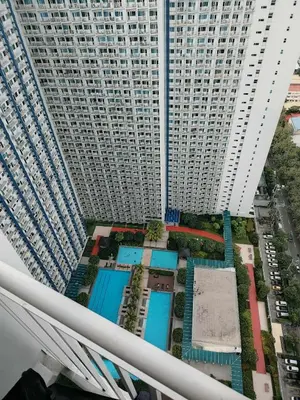 an aerial view of a large building with pools at SM Jazz Residences, Makati City in Manila