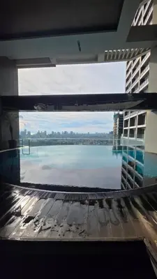 a view of the water from a window in a building at Urban Retreat at The Gramercy Residences Makati in Manila