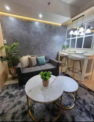 a living room with a couch and a table at cozy room at Sea Res in Manila
