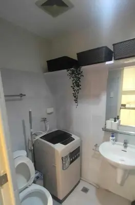 a small bathroom with a toilet and a sink at cozy room at Sea Res in Manila