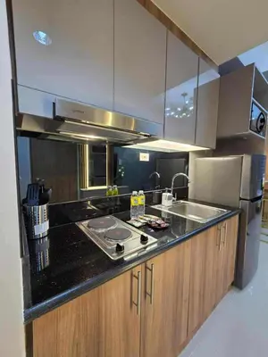 a kitchen with a sink and a counter top at Cozy Haven Suite at Shore 3 in Manila