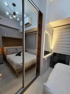 a bedroom with a mirror and a bed in it at Cozy Haven Suite at Shore 3 in Manila