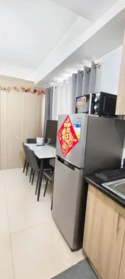 a kitchen with a refrigerator with a sign on it at Stand out and cozy condo unit at Shore 2 Tower 3 in Manila
