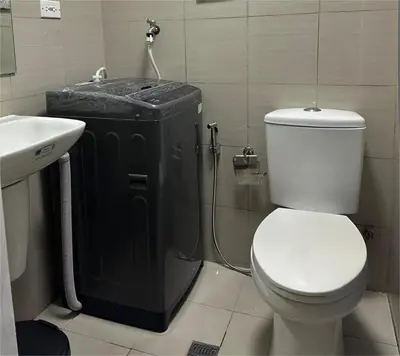 a bathroom with a toilet and a shower and a sink at Pyeong on Suite SMDC Shore Residences Mall of Asia Pasay in Manila