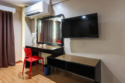 a room with a desk and a television on the wall at Hotel Sogo Baclaran in Manila