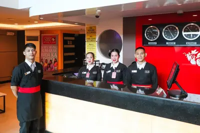 a group of men standing in front of a counter at Hotel Sogo Baclaran in Manila