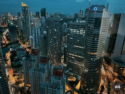 a view of a city at night at City View Skyline - Air Residence in Manila