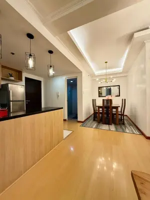 a living room with a kitchen and a dining room at Avant BGC 2 Bedroom in Manila