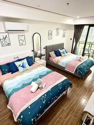 two beds sitting in a room with a mirror at Sy bay Suites TwinBed near Okada MOA PITX NAIA cod MSV1502H in Manila