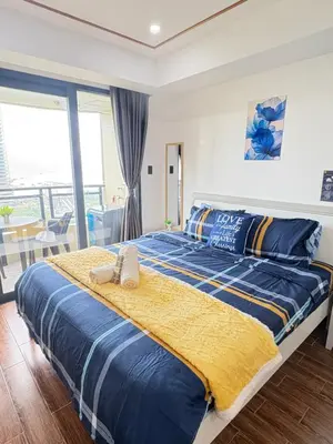 a bedroom with a large bed with towels on it at Sy bay Suites Okada NAIA T3 T1 Airport MOA COD DFA MSV1506H in Manila
