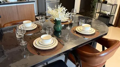 a table with plates and glasses on top of it at Casa Forma in Manila