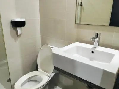 a bathroom with a toilet and a sink at #Affordable Condotel Newport Boulevard in Manila